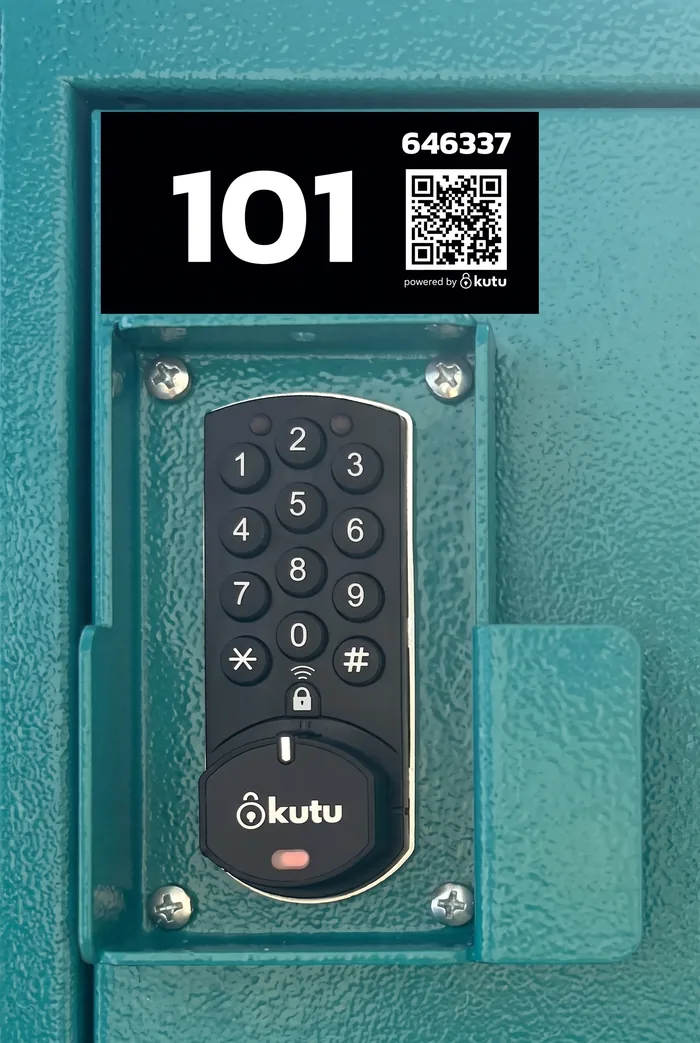 The teal metal door of locker 101 up close: the black label with its number and QR code, the Kutu keypad below.